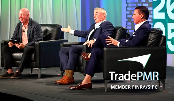 Robb Baldwin and Steve Quick in suits on the Synergy25 stage 